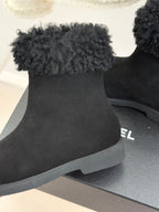 Black suede ankle boot with faux-fur cuff and sculpted rubber sole