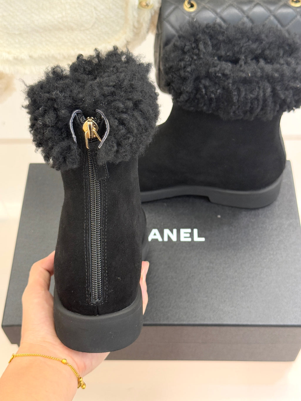 Black suede ankle boots with faux-fur cuffs, zip pull, and chunky sole