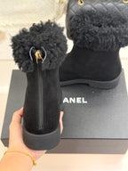Black suede ankle boots with faux-fur cuffs, zip pull, and chunky sole