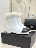 White women's ankle boots with black side panel and fluffy shearling cuff