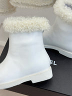 White women's ankle boot with black side insert and chunky rubber sole, close-up