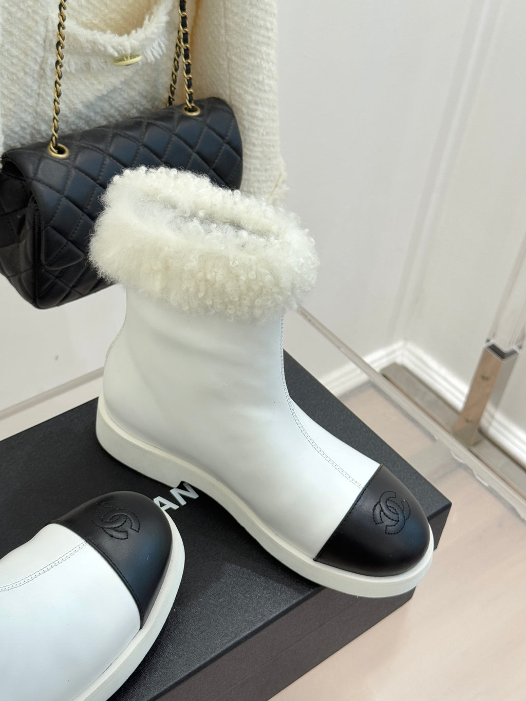 White women's ankle boots with fluffy cuff and black side insert, side view