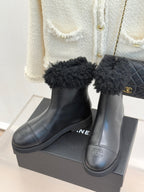 Black leather ankle boots with black faux-fur cuffs and side Chanel-style logo