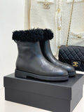 Black leather ankle boots with black faux-fur cuffs and chunky rubber sole
