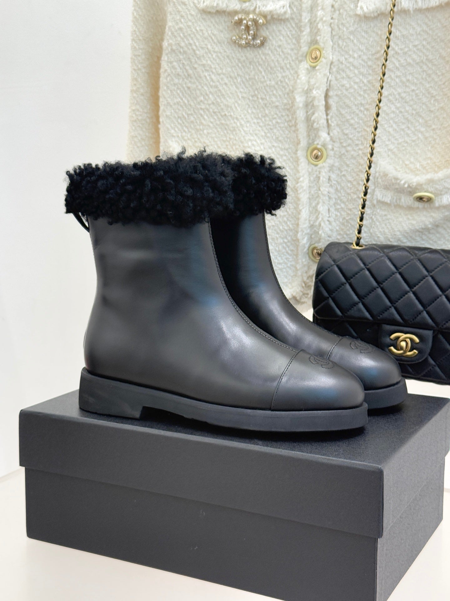 Black leather ankle boots with black faux-fur cuffs and chunky rubber sole