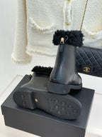 Black leather ankle boots with treaded rubber sole and side zipper