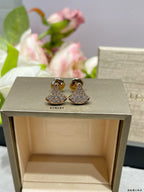 Pavé bell stud earrings set with two-tone crystal sparkle, in gold finish