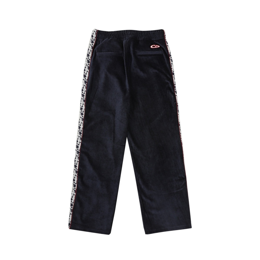 Navy drawstring pants with side logo trim and small red logo patch