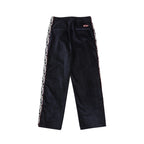 Navy drawstring pants with side logo trim and small red logo patch