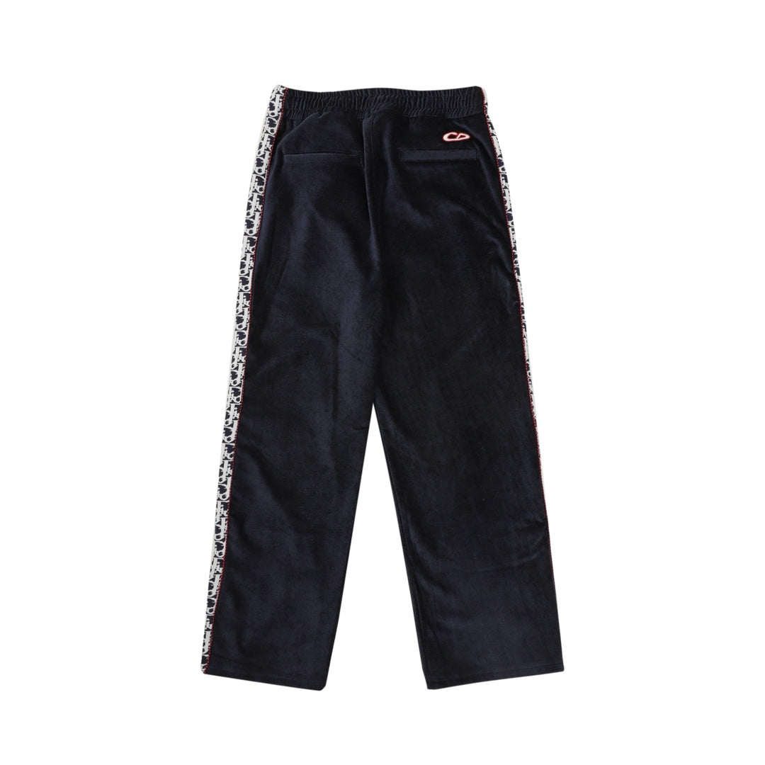 Navy drawstring pants with side logo trim and small red logo patch