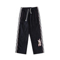 Navy drawstring pants with white drawcord and patterned logo side stripes