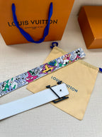 Louis Vuitton belt laid flat: white strap with multicolor graphic print and black LV buckle