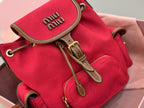 MiuMiu red mini bucket bag close-up of front flap hardware and leather straps