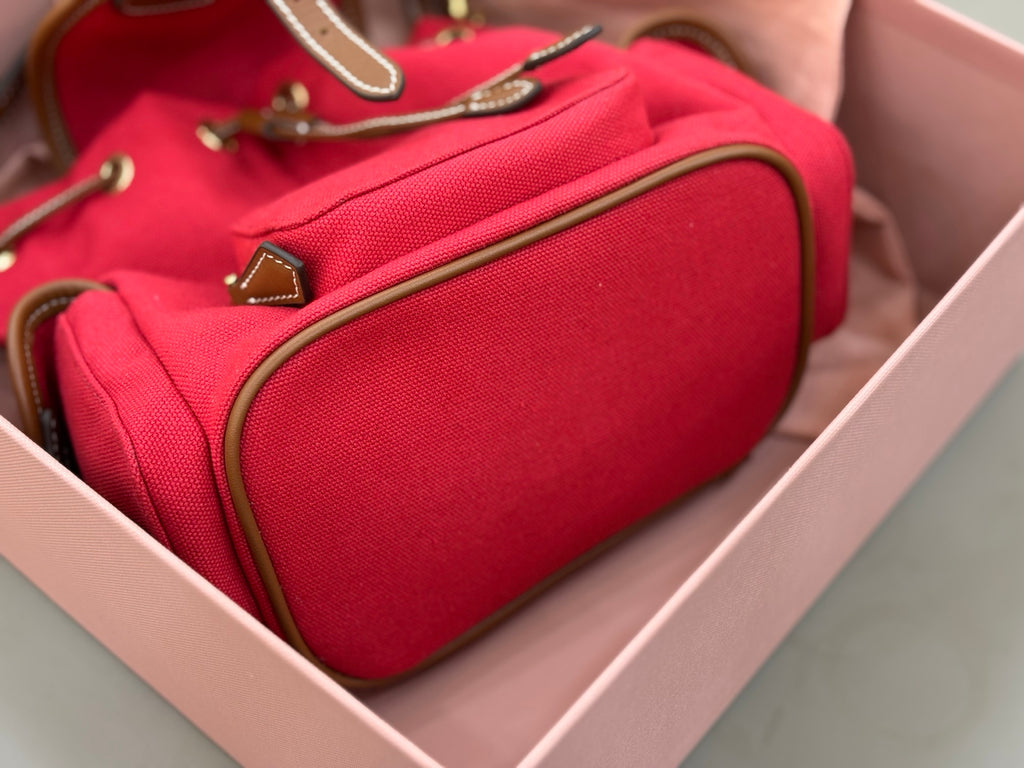 MiuMiu red mini bucket bag interior showing zip pocket and textured lining