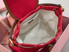 MiuMiu red mini bucket bag open interior with cream canvas lining and zip pocket