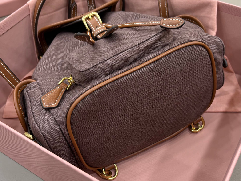 MiuMiu dark gray mini bag with top handle, rounded front pocket, gold-tone hardware