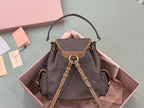 MiuMiu dark gray mini bag with front flap and drawstring cords, gold-tone rings