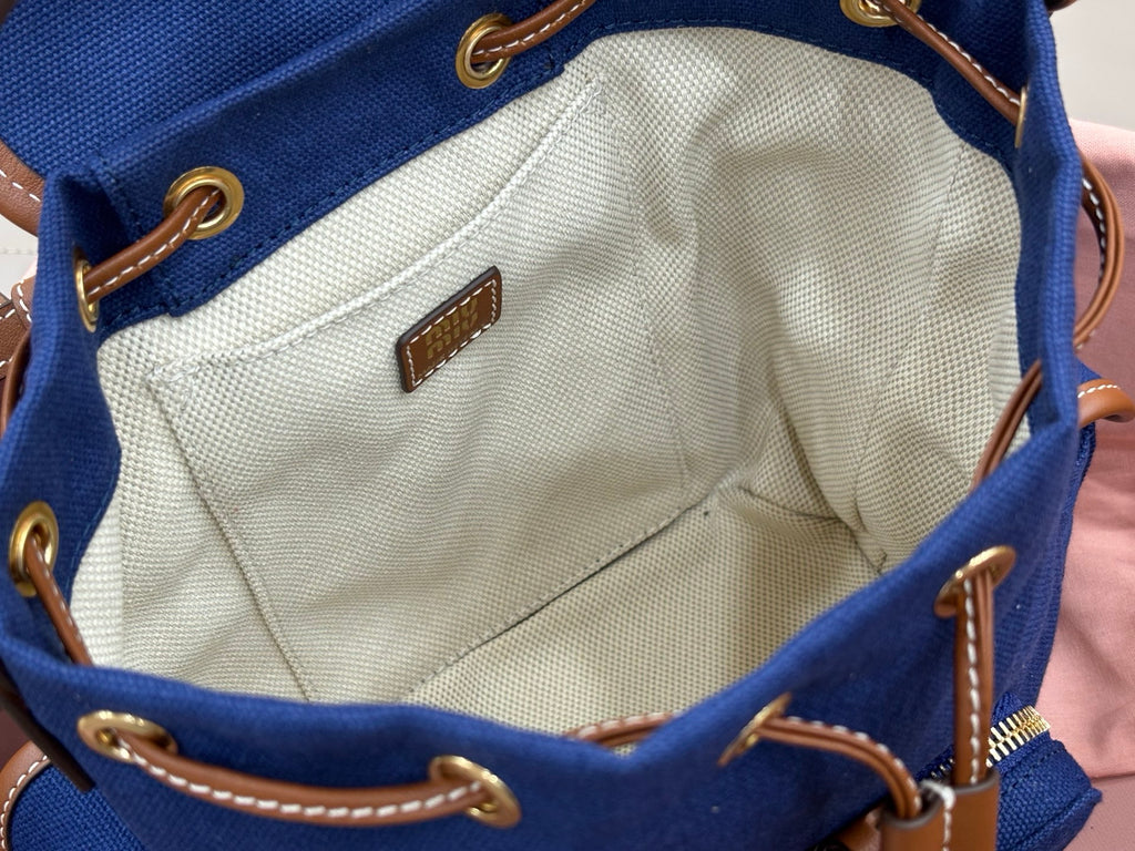 Miu Miu mini backpack interior with beige lining, stitched seams, and small leather label