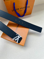 Louis Vuitton belt close-up: dark blue strap with perforation holes and gold-tone buckle
