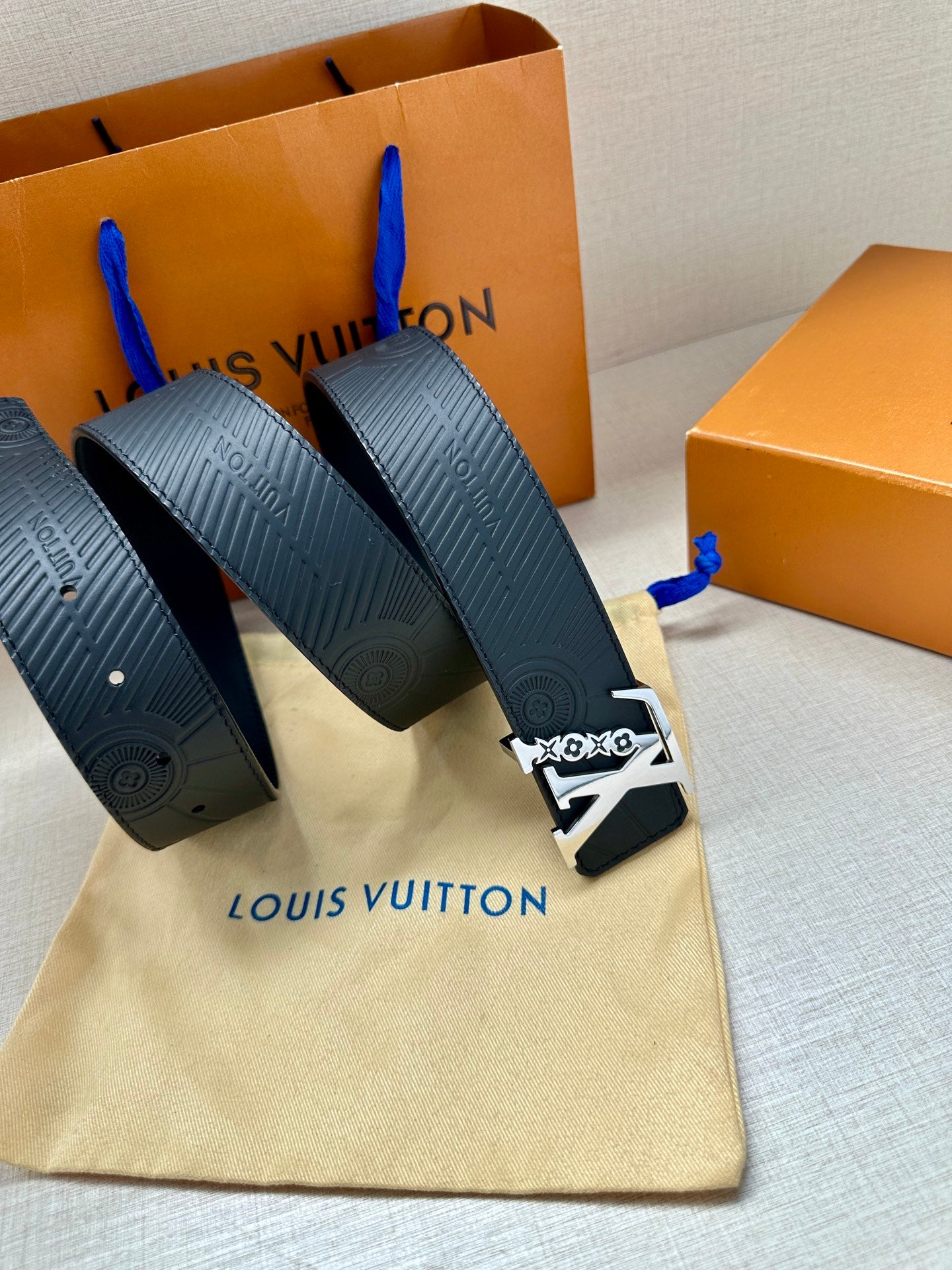 Louis Vuitton belt set in bag: dark blue embossed straps with gold-tone logo buckle