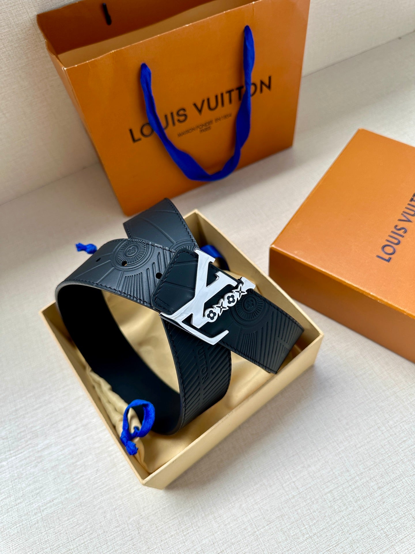 Louis Vuitton belt in box: dark blue embossed strap with gold-tone logo buckle
