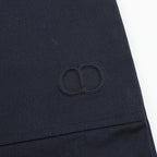 Dark navy stitched monogram patch on pant leg