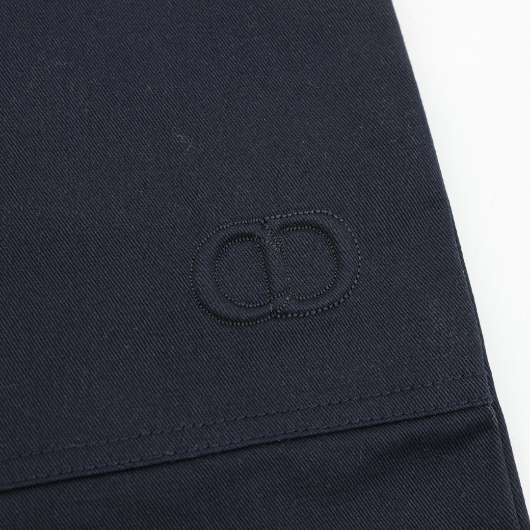 Dark navy stitched monogram patch on pant leg