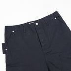 Dark navy pants close-up of front waistband and buttoned fly