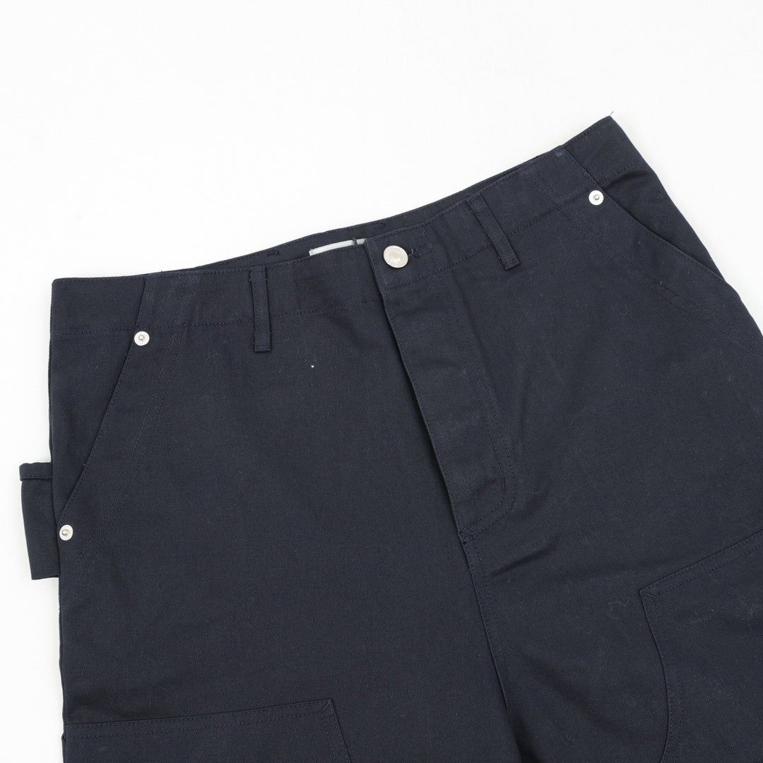 Dark navy pants close-up of front waistband and buttoned fly