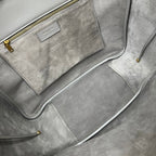 Gray suede tote with zippered interior pocket and gold zipper trim