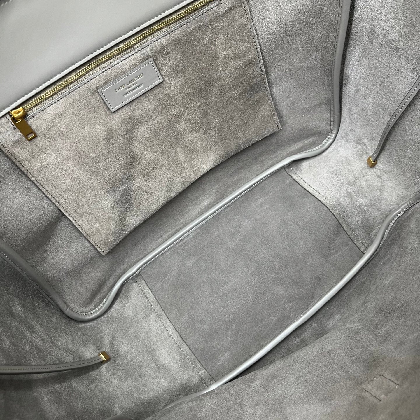 Gray suede tote with zippered interior pocket and gold zipper trim