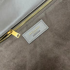 Gray suede tote label reading "SAINT LAURENT" with gold zipper pull
