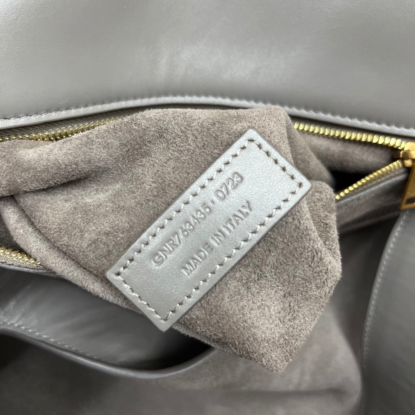 Gray suede interior label with "SAINT LAURENT" and model text on tag