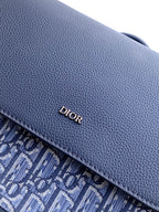 Blue leather Dior logo detail on backpack flap trim.