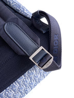 Navy Dior backpack bag close-up of strap hardware and top opening pull loop.