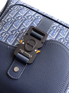 Navy Dior backpack bag close-up of front clasp and adjustable strap buckle detail.