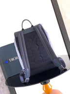 Dior backpack with structured front pocket and visible interior lining.