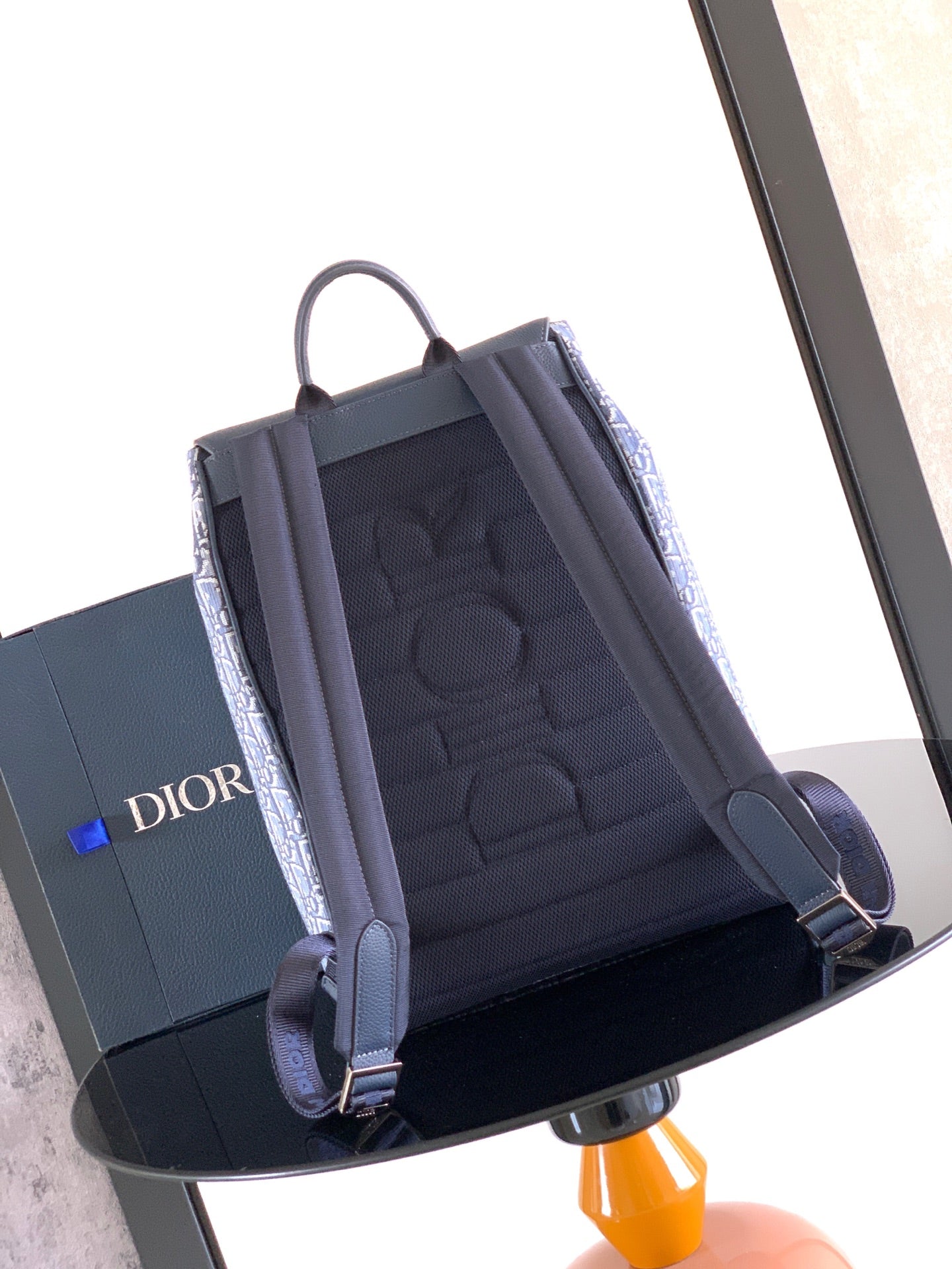 Navy Dior backpack bag interior view with front flap open, showing cushioned lining.