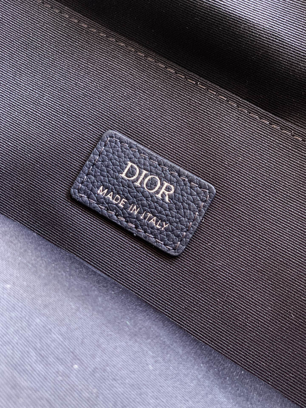 Dior men’s backpack interior label reading DIOR and Made in Italy