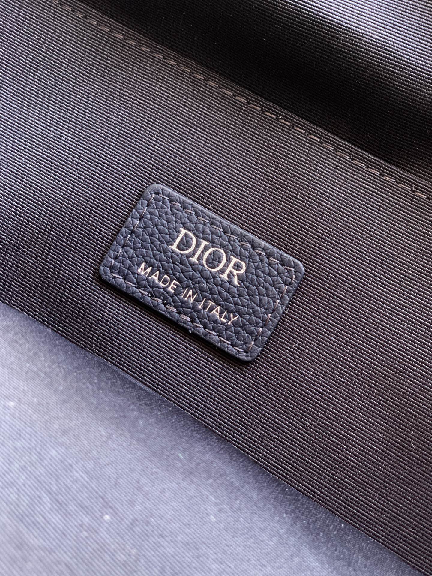 Dior men’s backpack interior label reading DIOR and Made in Italy