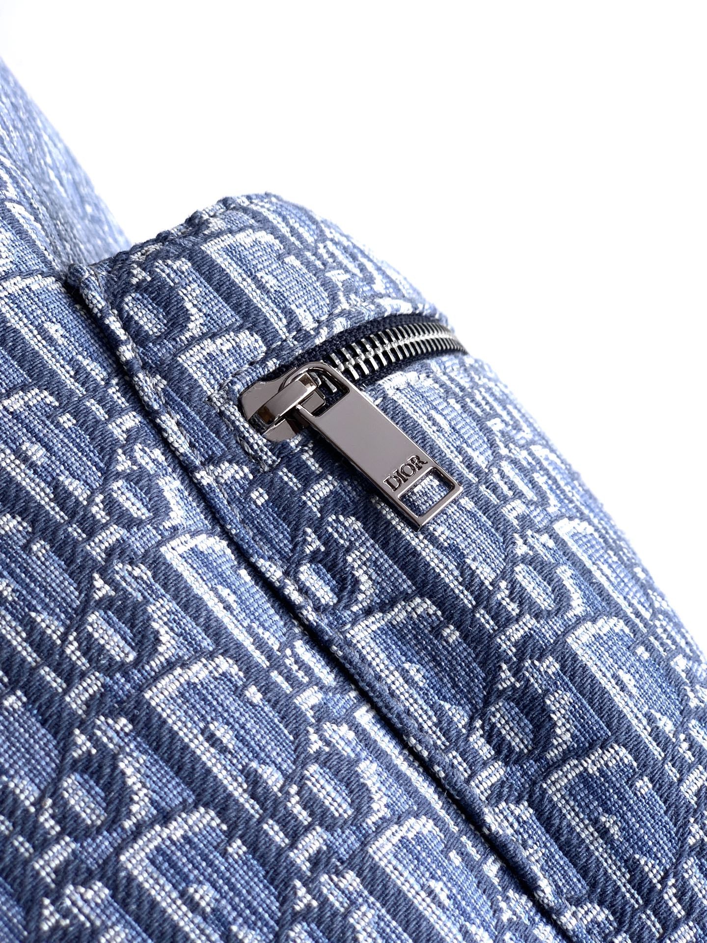 Dior mini monogram backpack, close-up of zipper and silver-tone hardware