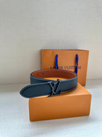 Louis Vuitton belt with dark blue strap and tan underside, silver buckle detail.