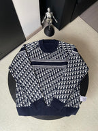 Dior long-sleeve sweater with navy and white repeating logo pattern and gray stripe