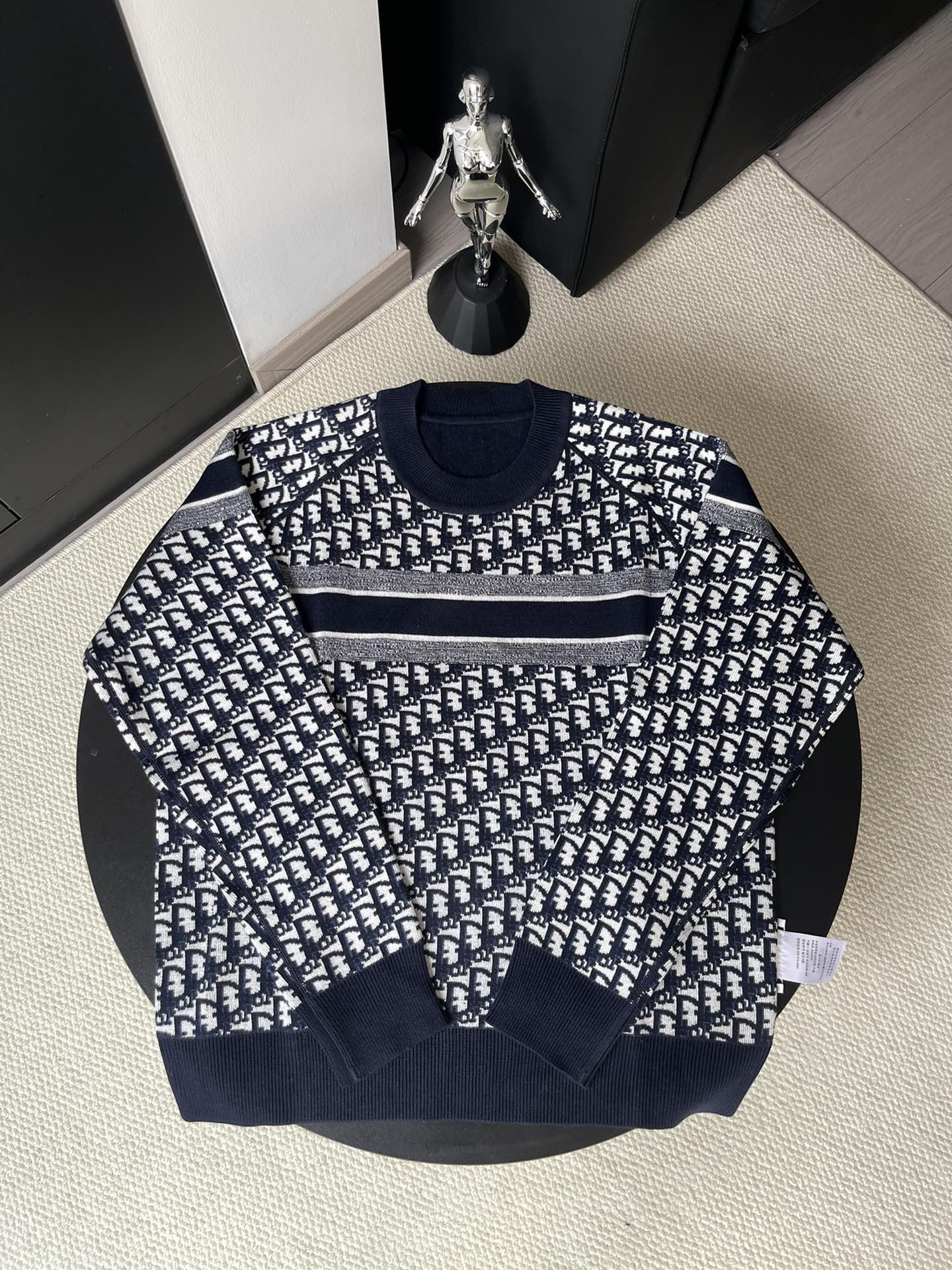 Dior long-sleeve sweater with navy and white repeating logo pattern and gray stripe