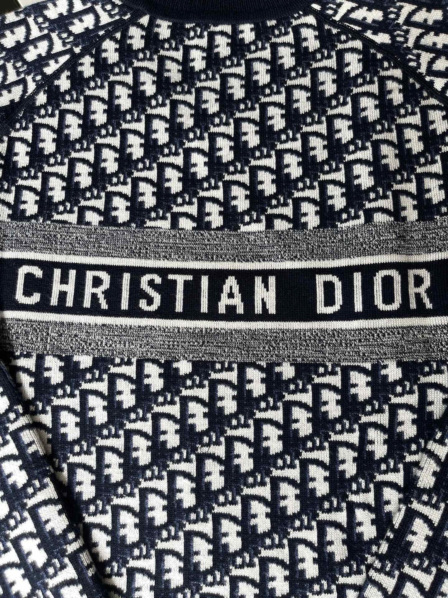 Dior long-sleeve sweater close-up with 'CHRISTIAN DIOR' logo band detail