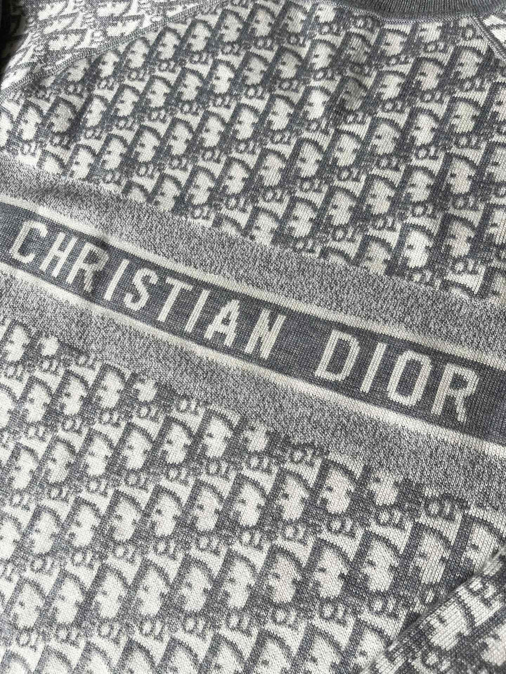 Gray sweater band with "CHRISTIAN DIOR" lettering and monogram background
