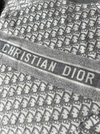 Gray sweater band with "CHRISTIAN DIOR" lettering and monogram background