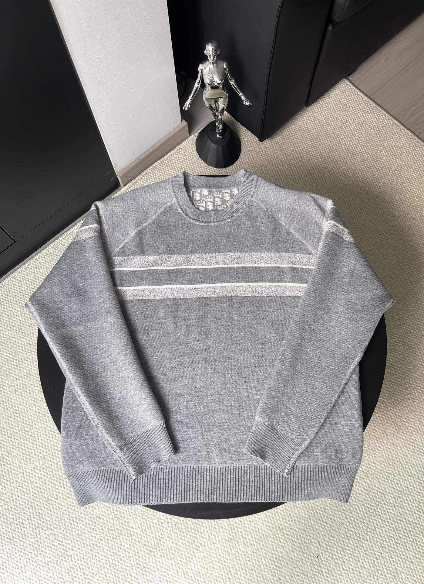 Gray long-sleeve crewneck sweater with horizontal logo stripes