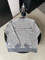 Gray long-sleeve crewneck sweater with monogram pattern and Christian Dior text