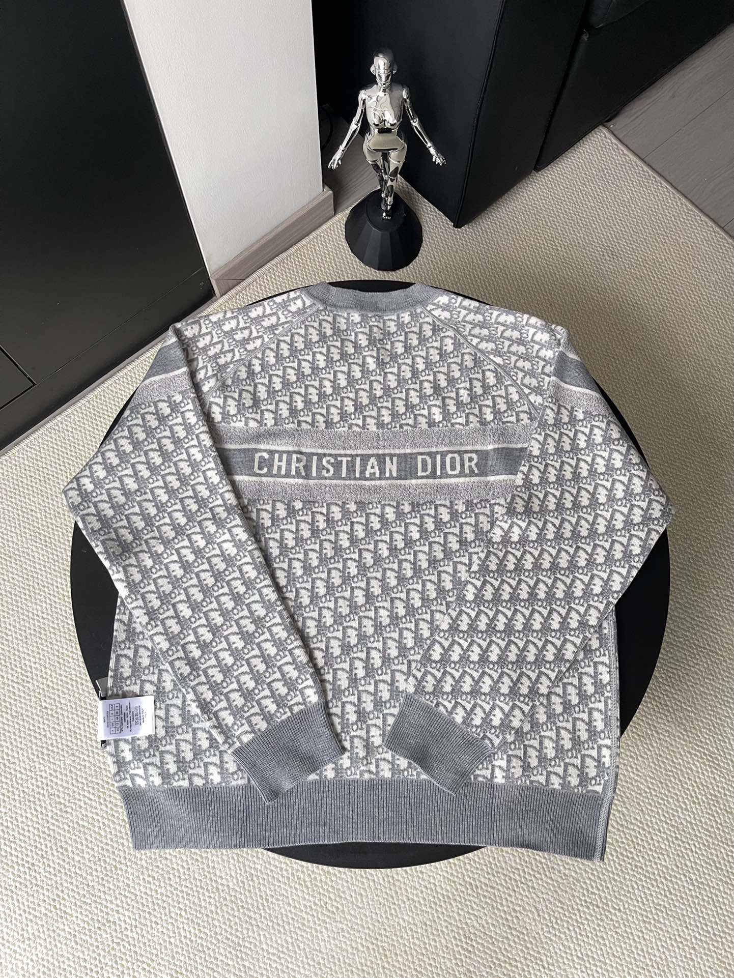 Gray long-sleeve crewneck sweater with monogram pattern and Christian Dior text
